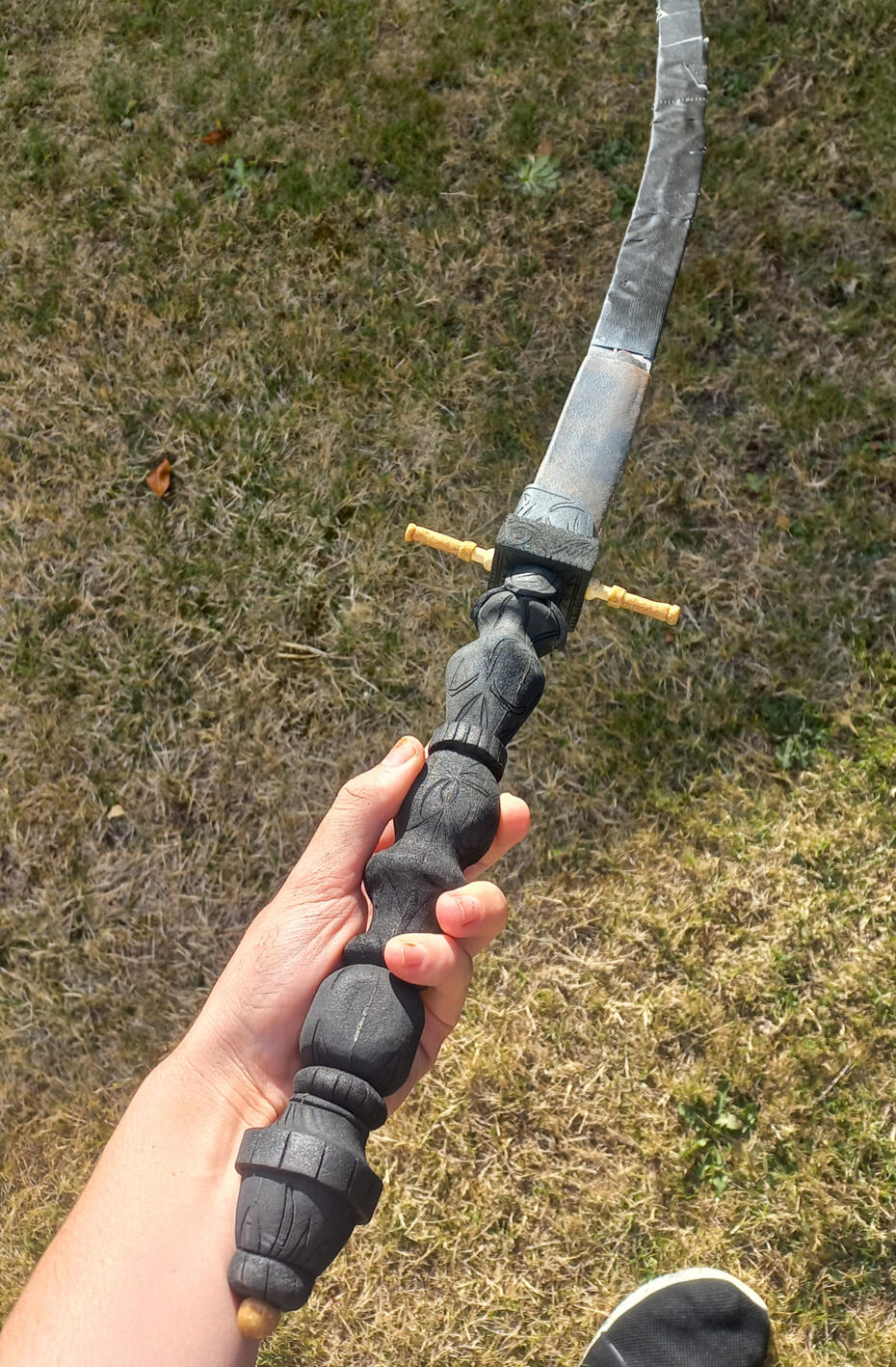 Work in progress photo of the Chikage weapon from Bloodborne, made from Worbla, EVA foam, and even some wooden thumbtacks which worked as the base from that odd little cross guard.